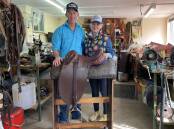Glenn and Victoria Davis in Glenn's workshop with a Stockman's Throne saddle. Picture by Simon Chamberlain