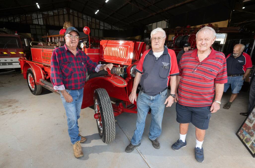 Nyngan Fire and Rescue captain Rob Avard with Tamworth Classic Fire Engine Club vice president Brian Hoy and president Barry Owen and the restored 1924 Garford fire engine which has been returned to Nyngan. Picture by Peter Hardin