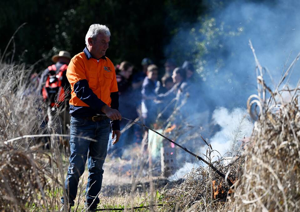 Kamilaroi man Len Waters helps with burnings. Picture by Gareth Gardner