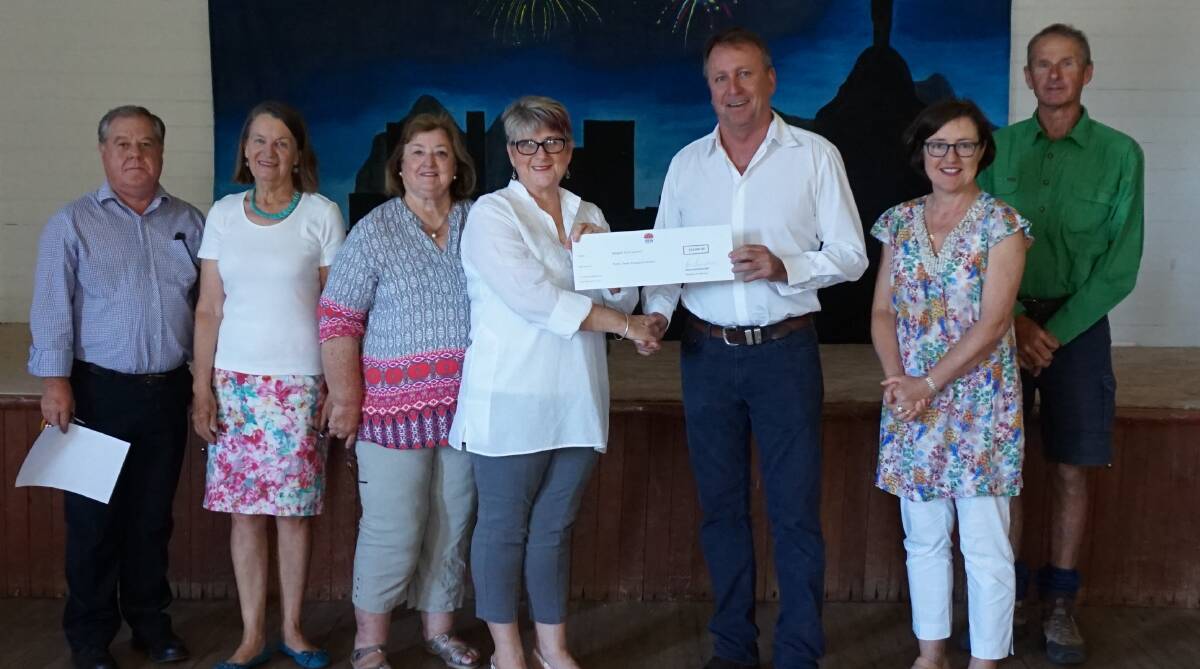 Cheque handover: Michael Urquhart, Coral Marshall, Elizabeth Powell, Tanya Cameron, Kevin Humphries, Lucinda Stump and Phillip Powell.
