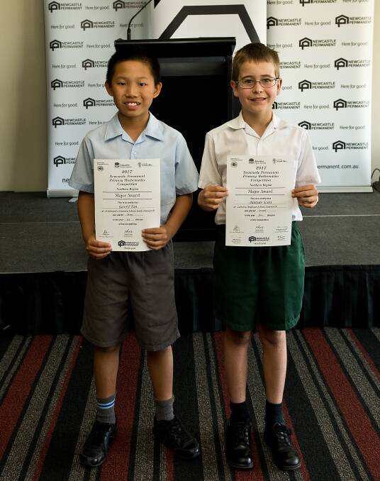 Well done: St Edward's Primary School year 6 student Gavril Tan and Calrossy Anglican School year 5 student Alistair Scott with their awards. Photo: Supplied.