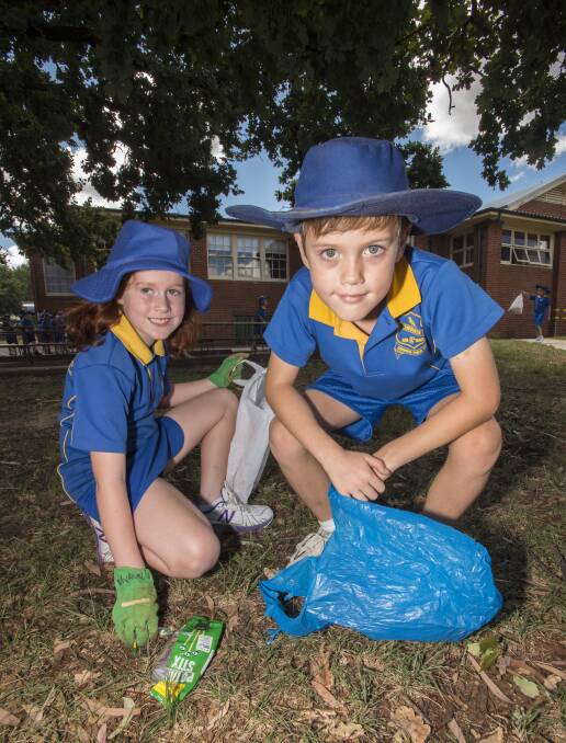 Schools clean up: Mykayla Hensby and Thomas Sylvester pulled on their hat and gloves and helped clean up the school grounds. Photo: Peter Hardin 030317PHD026