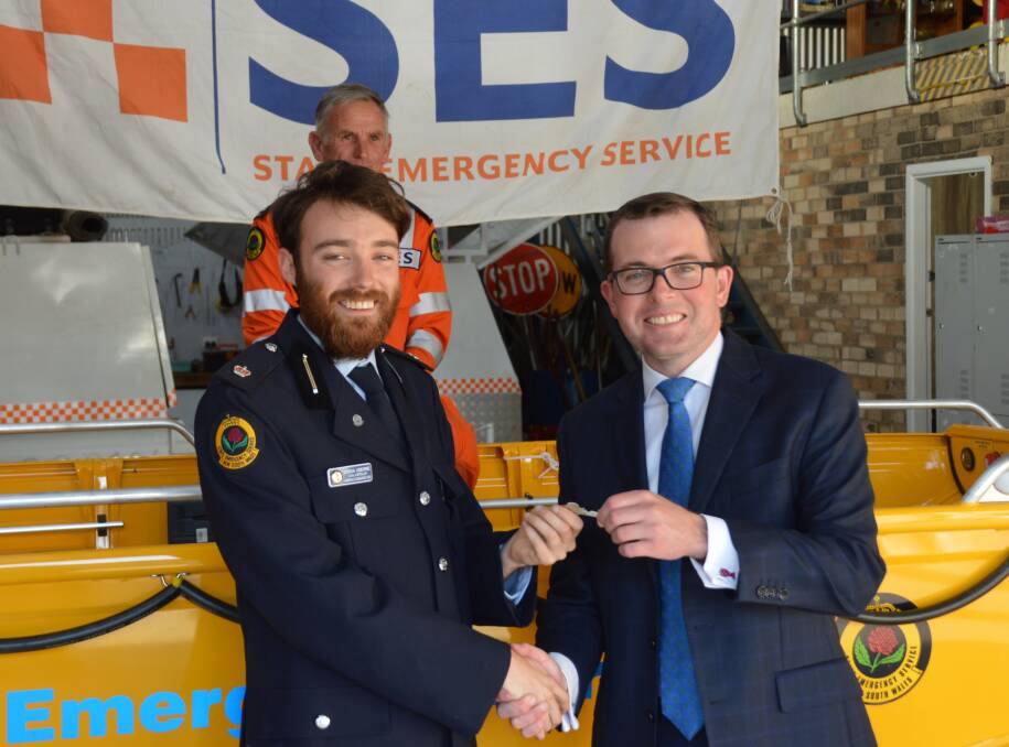 Flood ready: Northern Tablelands MP Adam Marshall, right, hands over the keys to the new $27,000 flood rescue boat to Armidale SES Unit Controller Josh Osborne.