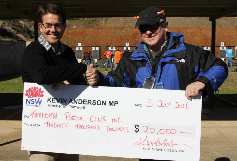 SAFE SHOOTING: Kevin Anderson presents a cheque for $20,000 to Tamworth Pistol Club president Phil Harris for safety upgrades.