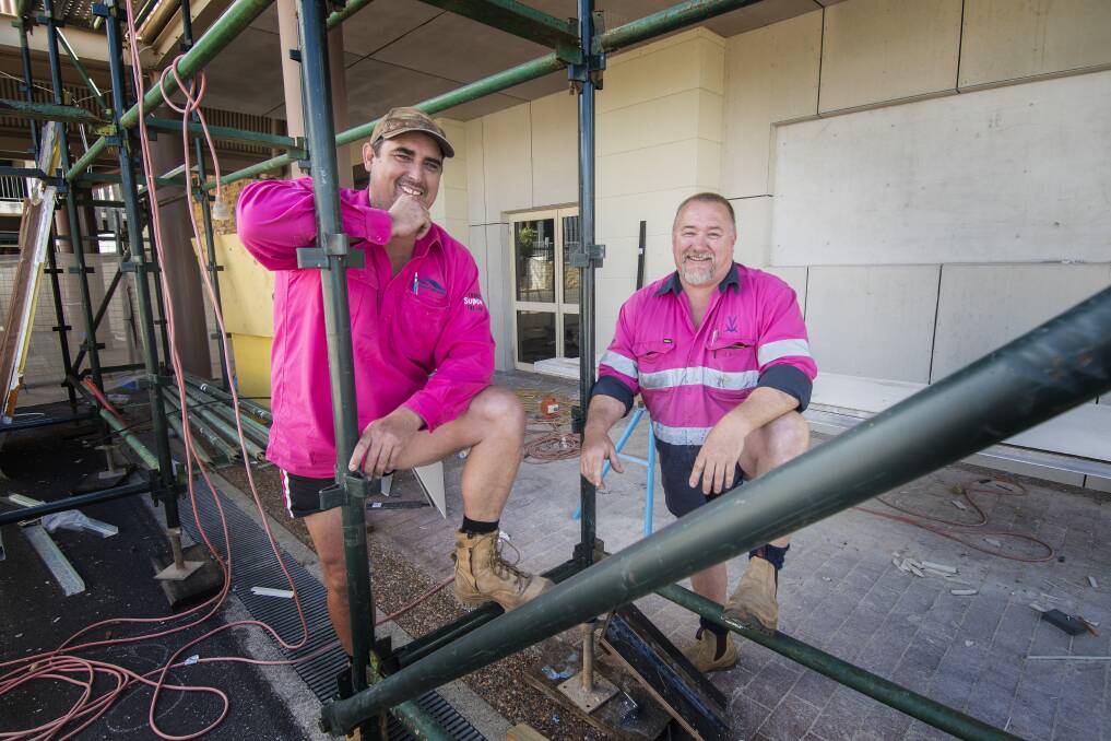 Pink and proud: Gary Sinclair and Matt Witson pinked up in solidarity with their wives, but now the movement has gone viral, and aims to make a difference. Photo: Peter Hardin