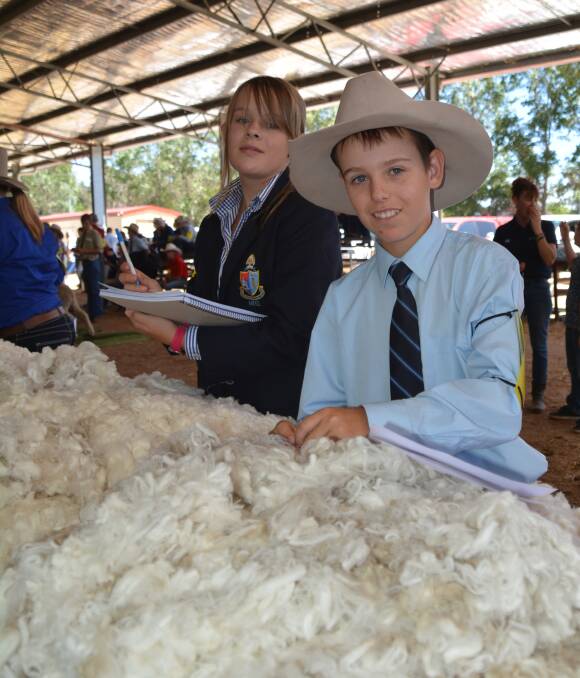 New skills: Zoe Stuart (New England Girls' School) and Nicholas Graham (O'Connor Catholic College) were two of the 70 students who took part in the junior fleece judging earlier this year at the Armidale housed ram show and sale.