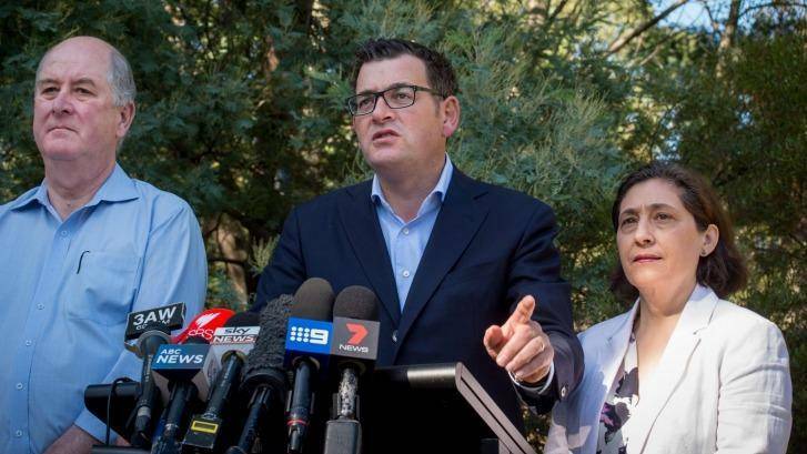 Premier Daniel Andrews, flanked by Planning Minister Richard Wynne and Environment Minister Lily D'Ambrosio, talks to the media on Sunday. Photo: Penny Stephens