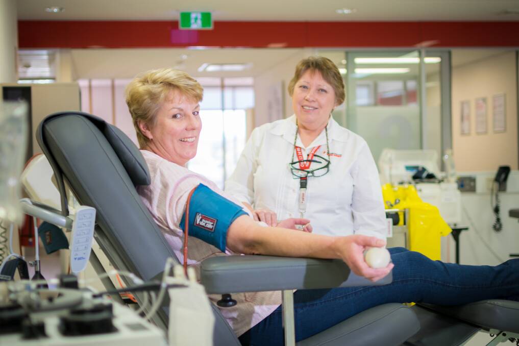 THE GIFT OF GIVING: Kate Chillingworth donates blood, under the watchful eye of Margaret Woischwill at the Tamworth Red Cross centre. Photo: Simon McCarthy