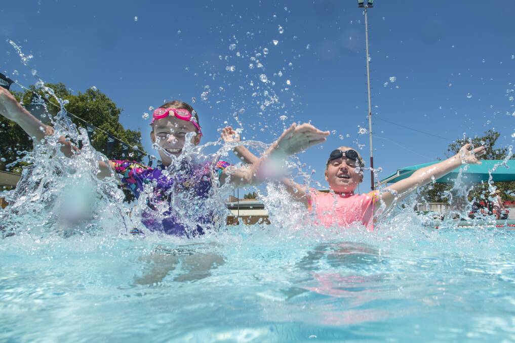 BEAT THE HEAT: Mia Robinson and Ellie Webster escape the warm water in the cool waters of Tamworth City Pool. Photo: Peter Hardin