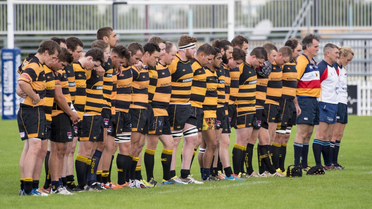 LOST BROTHER: The Pirates pause for a minutes silence to remember Jack Cutcliffe in their trial game against Balmain on Saturday. Photo: Peter Hardin 010317PHE005