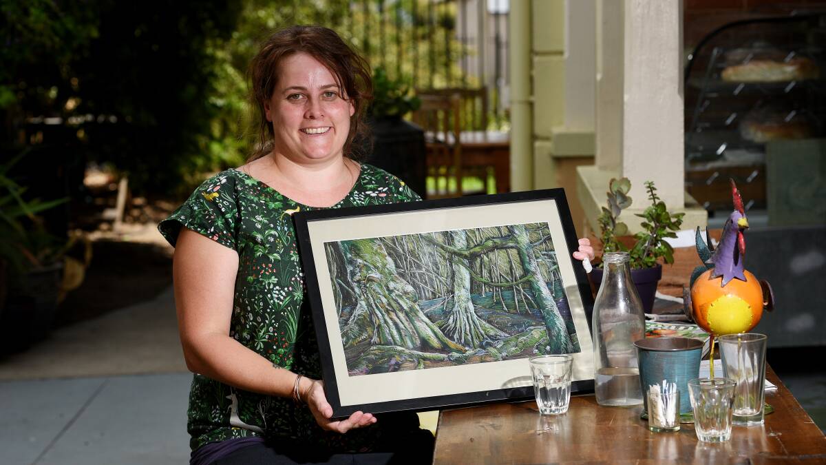 ADVENTURE: Sally Doherty with the artwork she raffled off to raise money to travel to the Tarkine. Photo: Gareth Gardner 140217GGD01