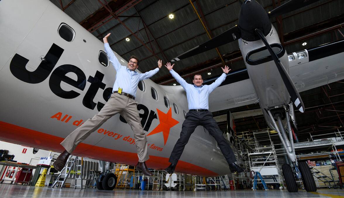 JUMPING FOR JOY: Kevin Anderson and QantasLink base maintenance manager Glen Reedy with the first Jetstar plane to get a checkup. Photo: Gareth Gardner 050517GGD16