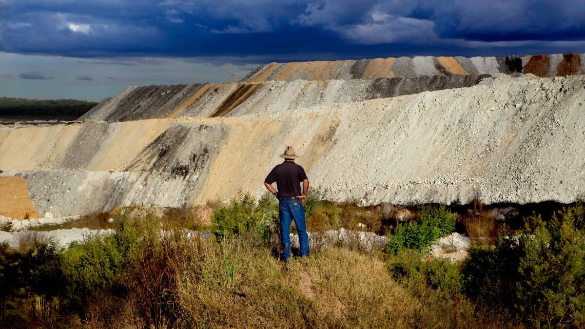 DUST ISSUE: A farmer looks on over the Boggabri coal mine. Photo: Dallas Kilponen