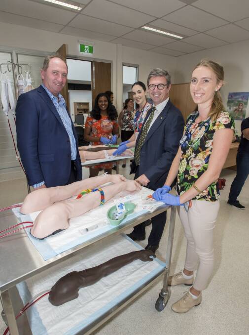 SAFE HANDS: Barnaby Joyce and David Gilliespie with aspiring doctor Bryony Beal take a tour of Tamworth's medical training hub. Photo: Peter Hardin 030317PHC062