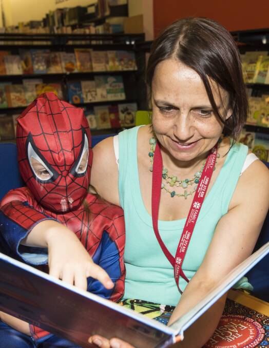 READING SUPERPOWER: Lily (aka Spider-Kid) and Jacqueline Smith enjoy a book together at Tamworth library. Photo: Peter Hardin 281116PHD002