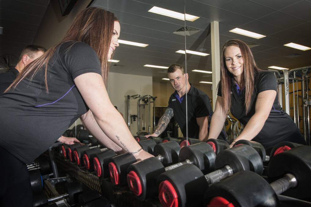 LIFTING THEIR GAME: Emily Bennett and Jake Starky said the expanded gym had more room, new equipment and new group fitness classes. Photo: Peter Hardin 140317PHC054