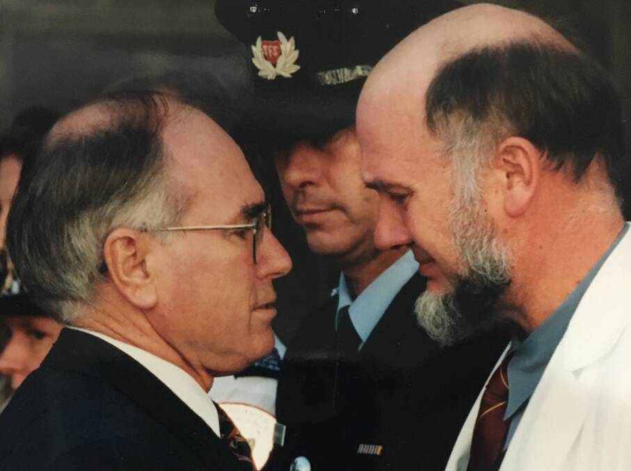EMOTION: Prime Minister John Howard comes face-to-face with surgeon Bryan Walpole who treated many of the victims. The men embraced and both shed tears.