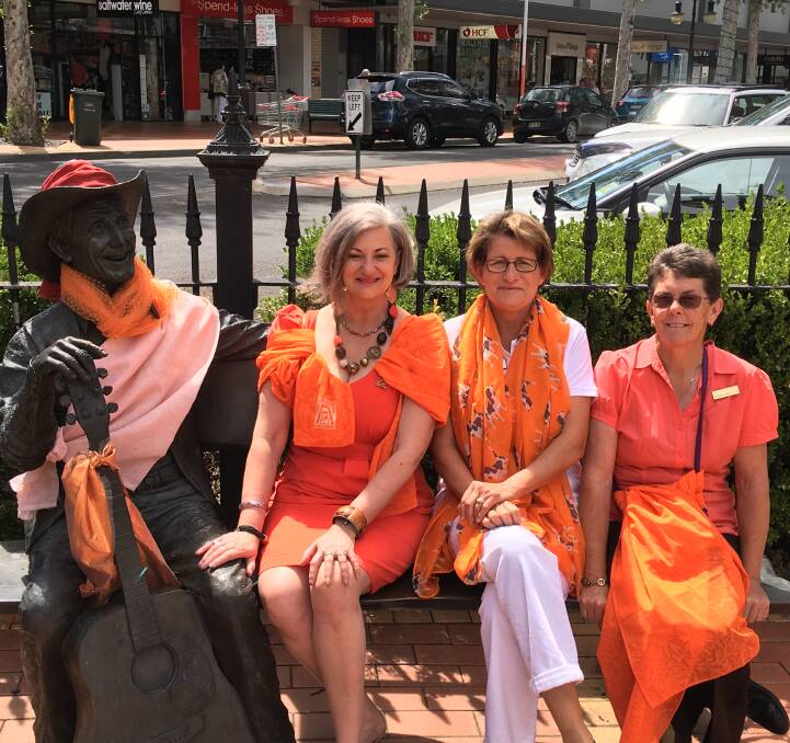 Colourful stand: Zonta members, president Deb Maes, Debrah Hubbard and Robyn Procter at the unveiling of the saying no to violence against women campaign on Friday in Peel St. Photos: Zonta Club of Tamworth 