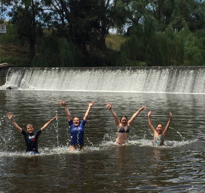 Splashing around: From left, Jye, Ava and Zoe Woodward, and Jayda Constable try to stay cool from the sizzling heat by taking a dip in the Manilla Weir. Photo: Breanna Chillingworth