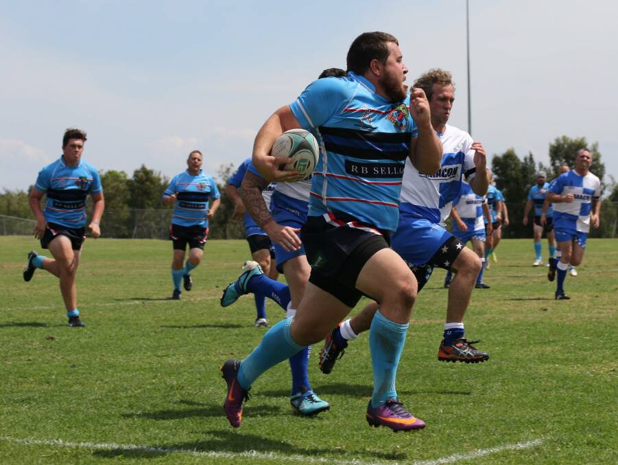 On the charge: Brodie Sowter in full flight as he makes a break down the sideline in Salamander Bay. Photo: Oxley Cods