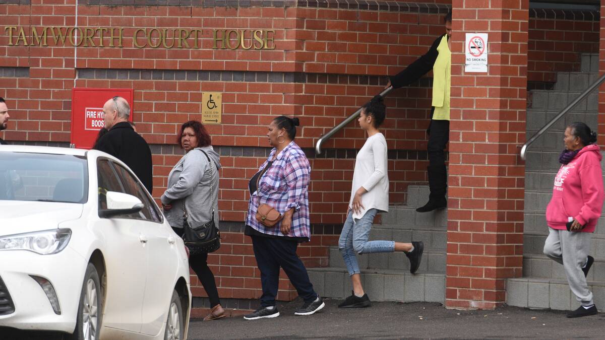 Trial continues: Family and friends of Johann Morgan with detectives outside of Tamworth court. Photo: Gareth Gardner