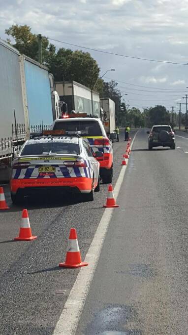 Traffic operation: Highway patrol officers inspect the loads of heavy vehicles in Boggabilla during the three-day blitz which targeted trucks and dangerous driving. Photo: NSW Police