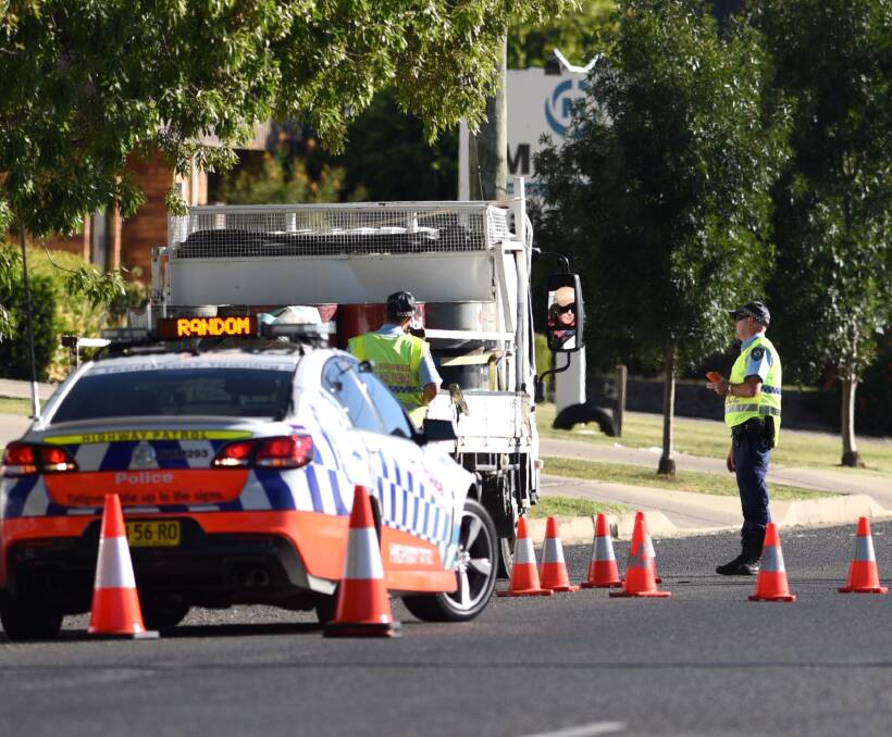 Traffic blitz: Highway patrol officers conduct random breath testing and vehicle stops on Jewry St in Taminda on Friday afternoon. Photo: Gareth Gardner