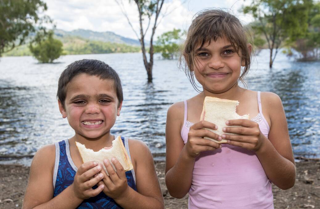 Chomping at the bit: Chaffey Dam campers Zac Tighe and Jakaya Newman have a bite to eat on the side of the water. 