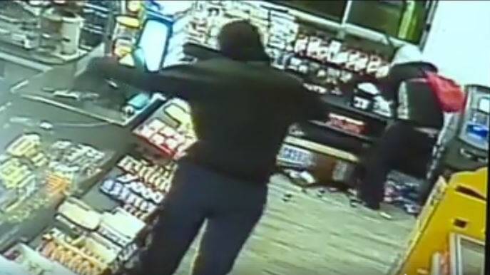 MANHUNT: CCTV video of the two armed robbers inside the Matilda Service Station on Thursday morning. Image: Prime7 News