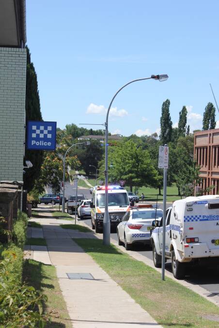 Hospitalised: Paramedics, pictured at the police station, transported one male who was arrested after the Armidale chase to hospital on Tuesday. Photo: Madeline Link