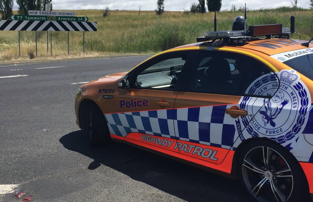 Keeping watch: Sergeant Michael Buko conducts speed enforcement duties using a lidar on the New England Highway ahead of Christmas. Photo: Breanna Chillingworth