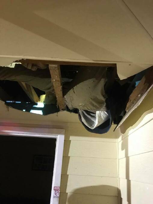 Delicate rescue: Firefighters had to break part of the roof to rescue the man on Sunday night. Photo: Fire and Rescue NSW