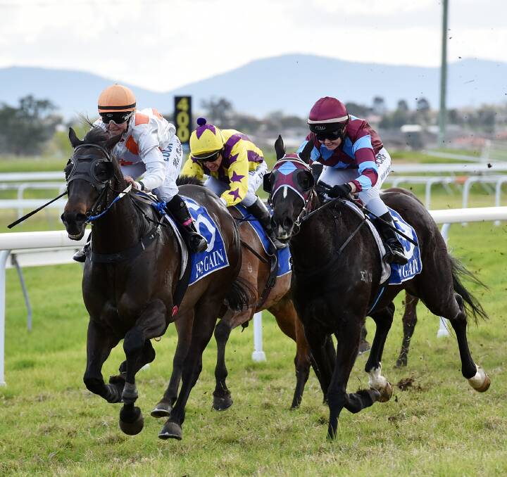 Hat Trick: Apprentice jockey Melanie Bolwell, pictured left aboard One Tin Soldier, streaks ahead to claim the Advanced Inland Security Benchmark 55 Handicap. Photo: Gareth Gardner 270916GGB04