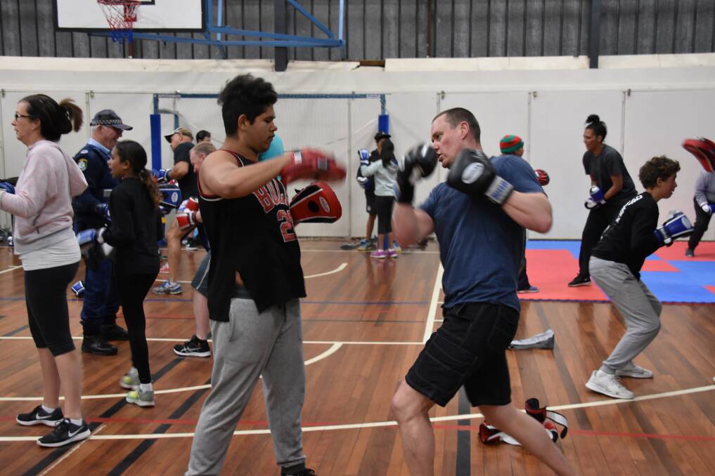 Fighting fit: Detective Sergeant Matt Crotty in action in training this week with some of the kids in the Nanyapura boxing program at the Armidale PCYC.