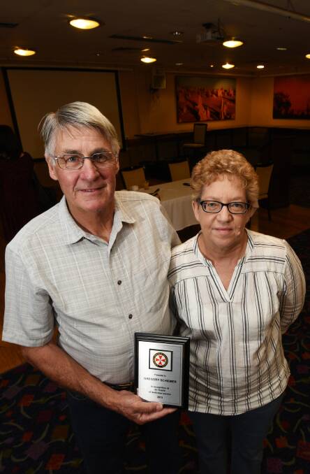 Recognised: Gregory Schiemer, with wife Sheryl, was honoured at the ceremony in Tamworth on Wednesday for 38 years of service. Photo: Gareth Gardner 150217GGE05