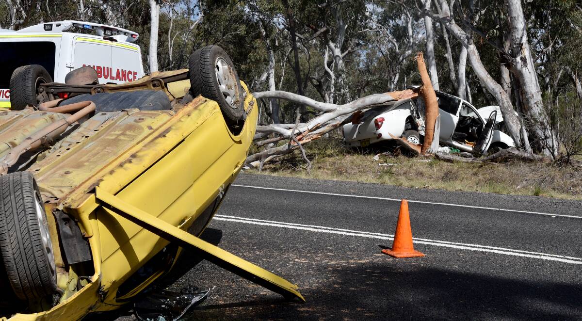 Crash scene: The flipped wreckage of Ryan's yellow sedan and the utility on the highway between Bendemeer and Uralla in 2015. 