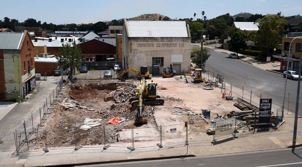 Going down: Demolition crews knocked down the last of the remaining walls of the old BWS bottle shop on Brisbane St to make way for the expansion to the CH on Peel hotel. Photo: Gareth Gardner 120217GGE02