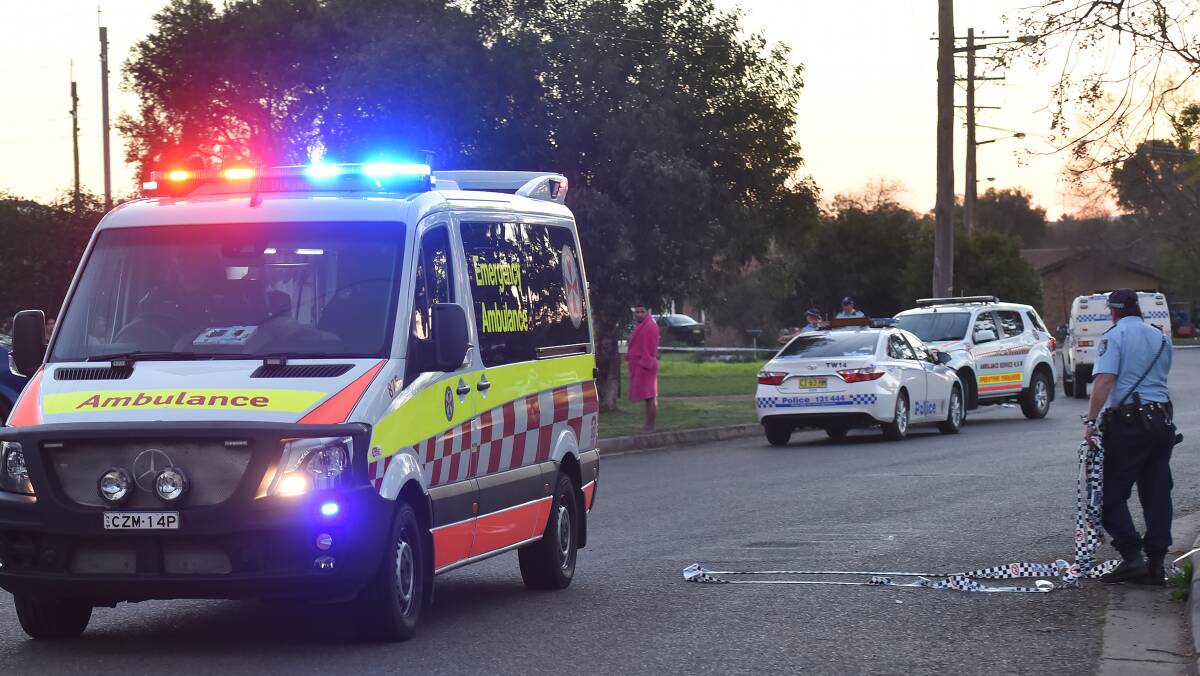 EMERGENCY: Paramedics rush a man with multiple stab wounds from Sue Cr on Wednesday. Photo: Gareth Gardner