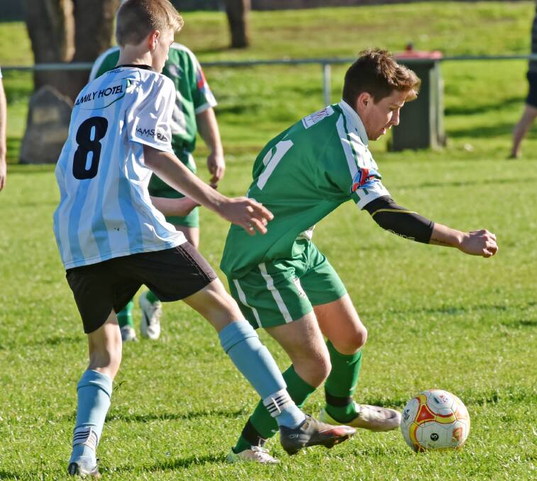 ON THE OFFENCE: East Armidale's Corby Kliendenst takes on Tamworth FC's Ryan Davidson last weekend ahead of Silent Saturday this weekend.