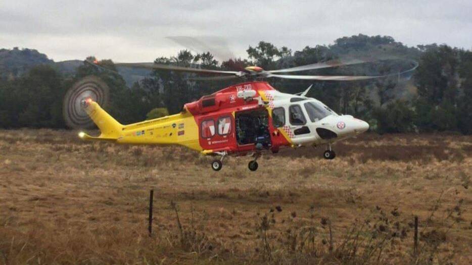 Taking off: The Westpac Rescue Helicopter leaves the scene of the crash near Woolomin, on the outskirts of Tamworth. Photo: Supplied