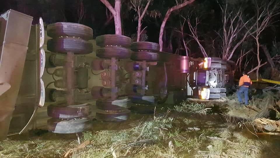 Truck rollover: The scene of the crash on the New England Highway near Bendemeer on Monday night. Photo: Fire and Rescue NSW