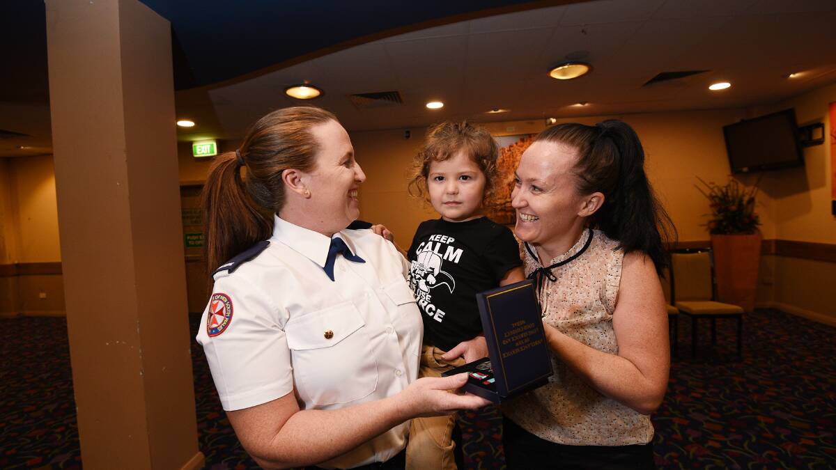 All smiles: Nicole Beacroft, left, with Aiden Beacroft, 3, and Erin Beacroft, was presented an award for her service. Photo: Gareth Gardner 150217GGE04