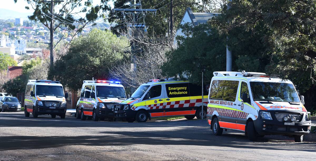 Ladder fall: Paramedics at the scene of the ladder fall in East Tamworth on Thursday afternoon. Photo: Gareth Gardner 