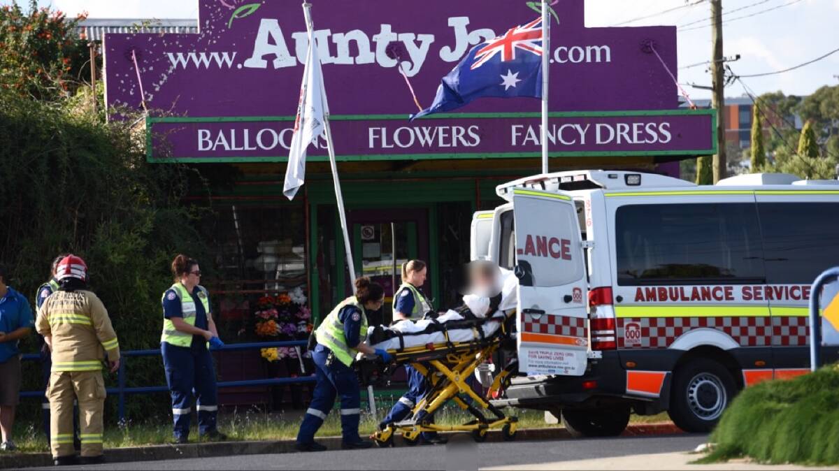 No serious injuries: Paramedics treat the motorcyclist at the scene in Tamworth. Photo: Gareth Gardner