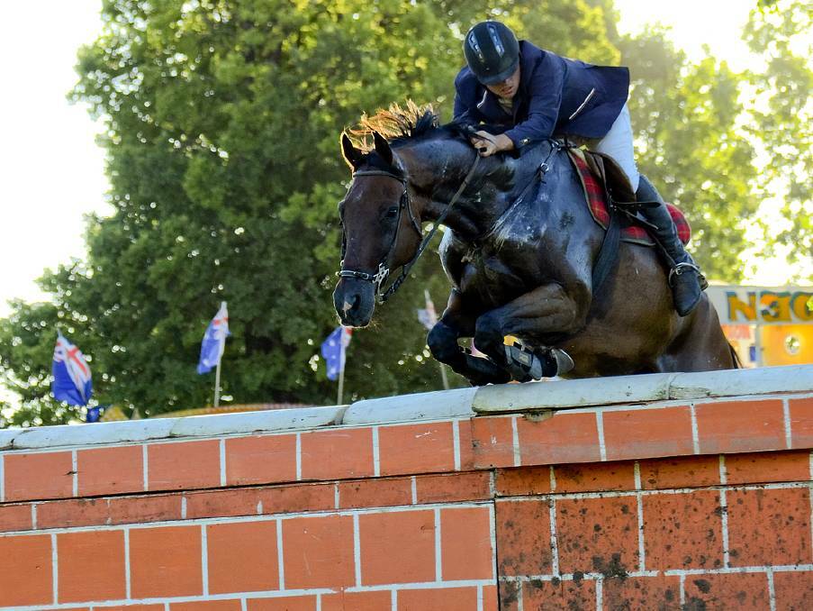 Clear jump: Brock Everingham makes it over the brick wall at the inaugural Glen Innes Spring Showjumping event last year. Photo: Supplied