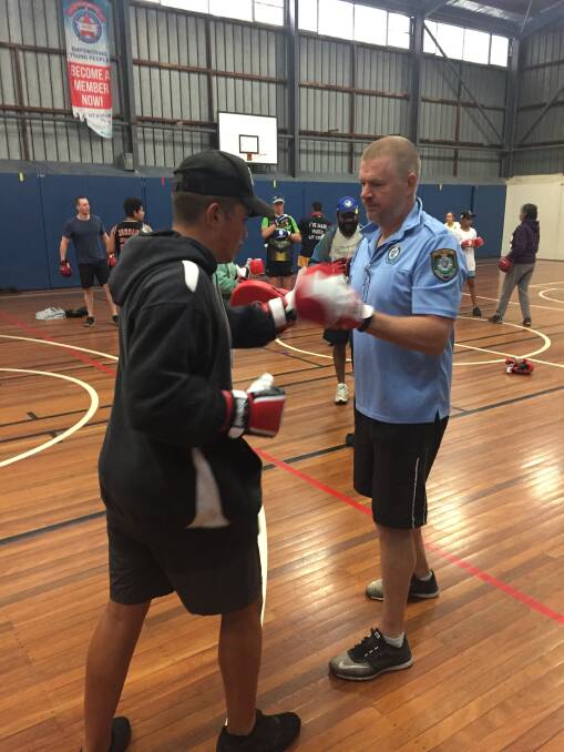 Packing a punch: Malakye, 15, trains with New England Police Inspector Roger Best, left, at the sessions held three times-a-week at the Armidale PCYC. 