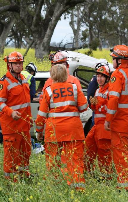 TWO-CAR CRASH: SES crews at the scene of the accident near Gunnedah on Thursday morning which saw one man taken to hospital. Photo: Sam Woods