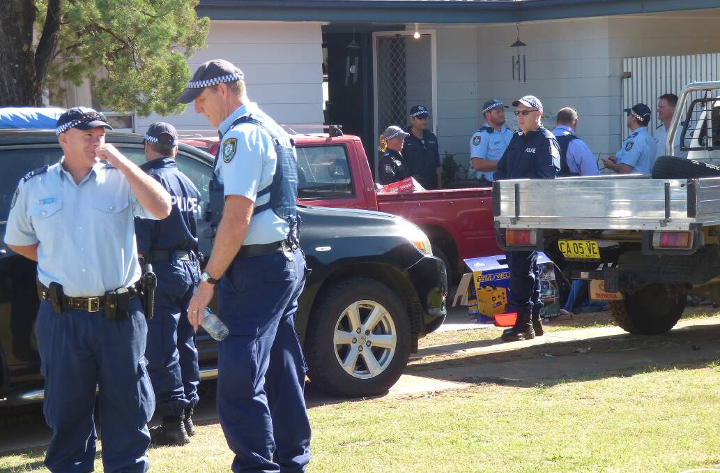 CO-ORDINATED RAID: Police at the front of one of the Hopedale Ave homes in during search warrants in February, 2015, as part of Strike Force Codes. 