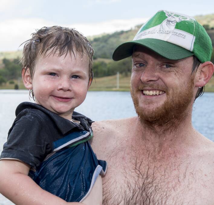 Wet, wet, wet: Campers James and Stephen Givney cool off for Christmas at Chaffey Dam near Nundle. 