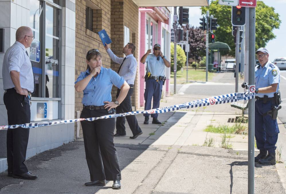 Crime scene: Oxley detectives and police comb the scene after a shot was fired into a Tamworth shopfront on Bridge St about 1.15pm on December 23. Photo: Peter Hardin